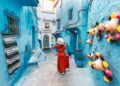 A tourist strolls through the blue city of Chefchaouen. / Photo: Kar-Tr / iStock